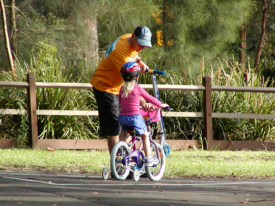 Adult and child biking